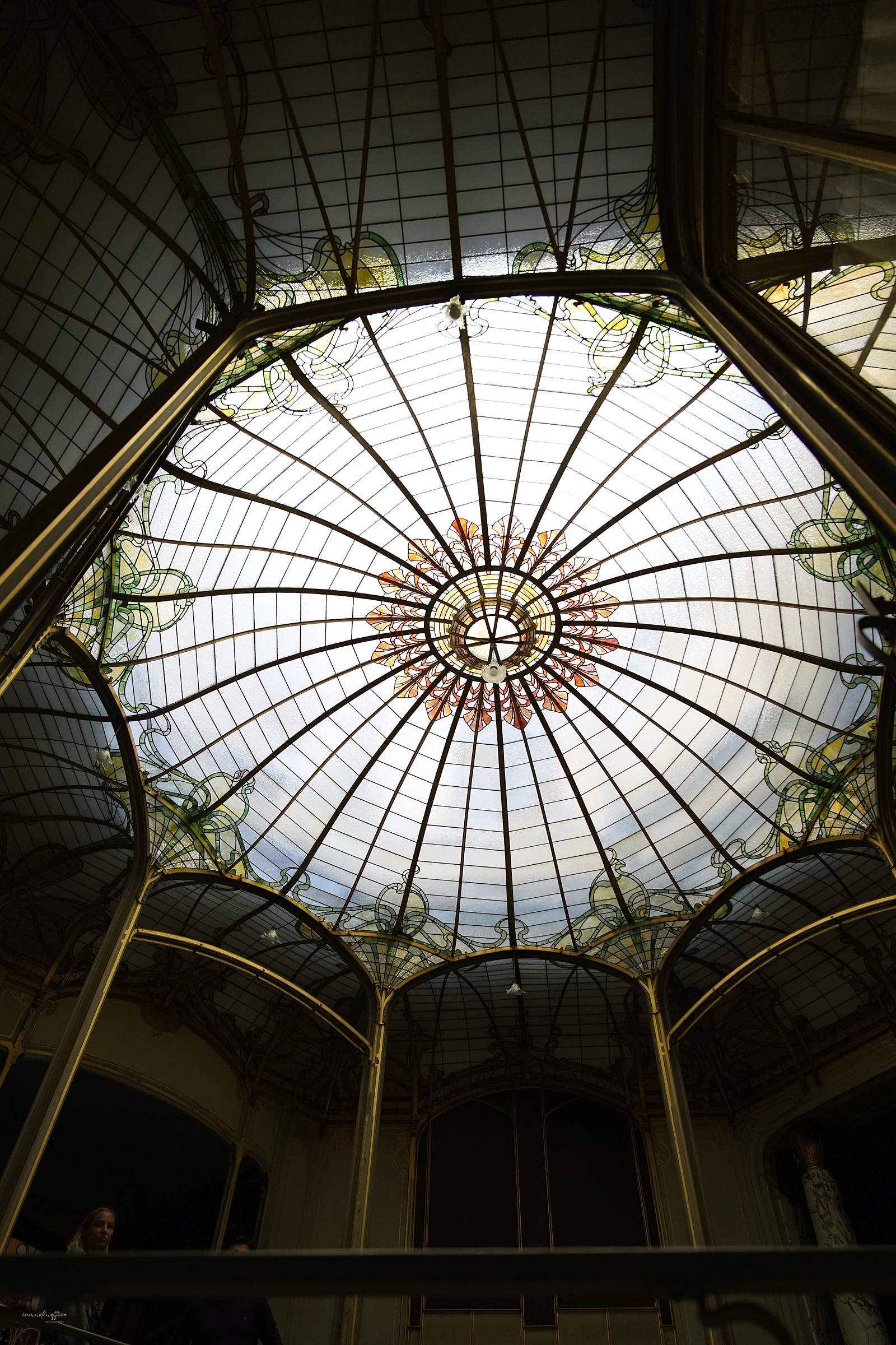 Ornate stained glass dome ceiling of an Art Nouveau building