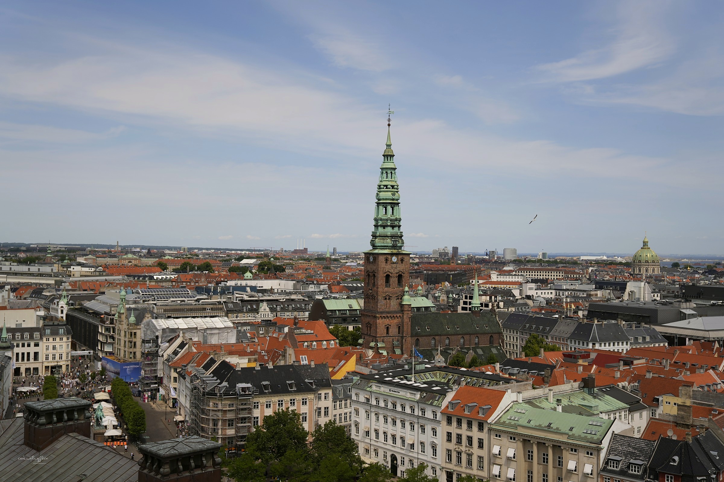 Copenhagen skyline with a green clock tower amid red rooftops