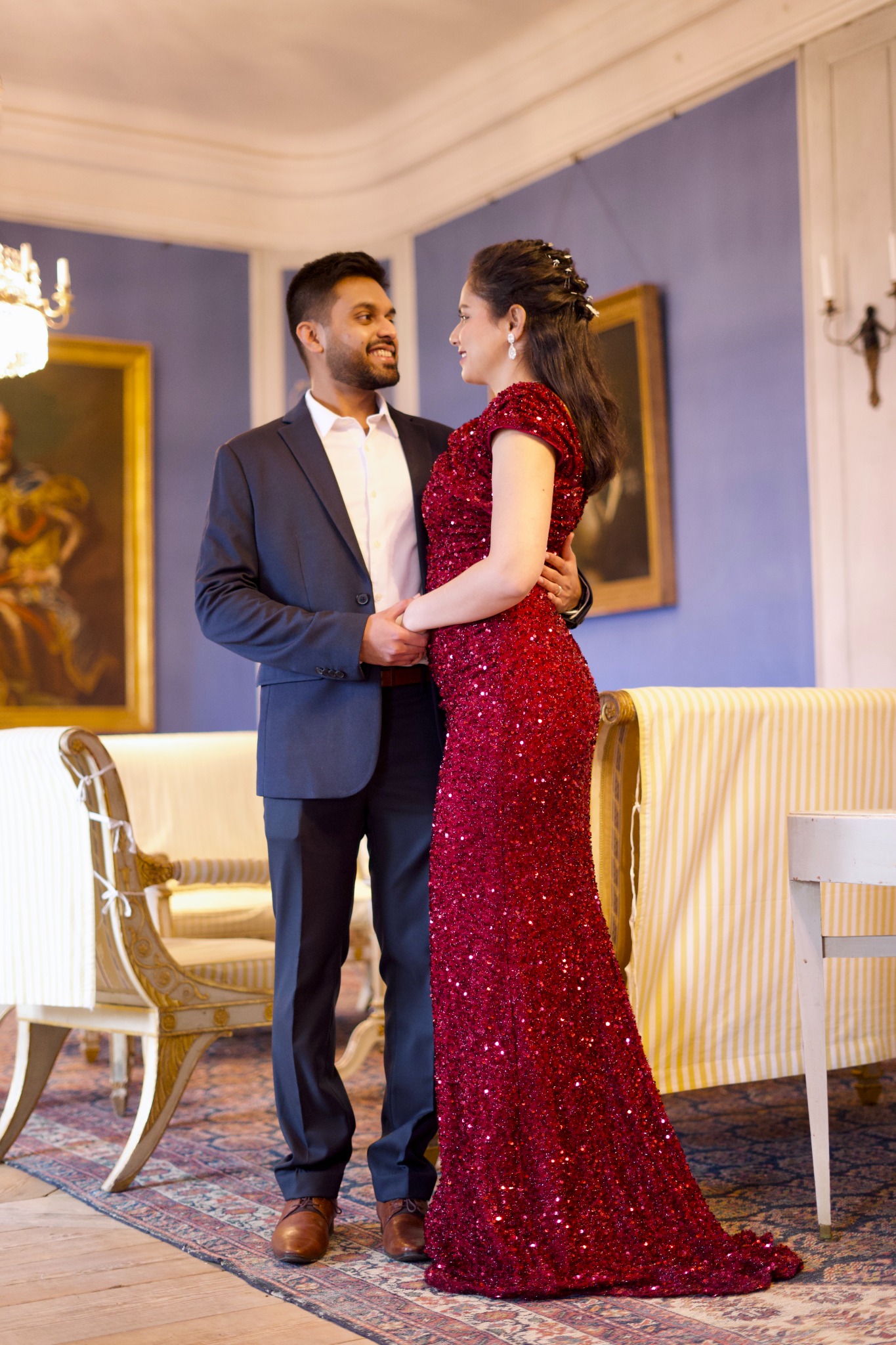 Couple together indoors, smiling and holding each other