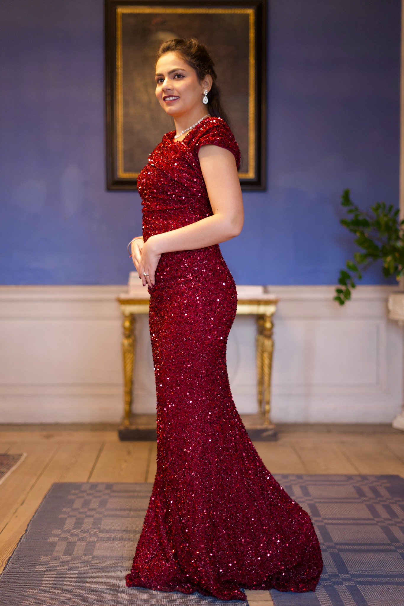 Portrait of bride in a red sequined gown indoors